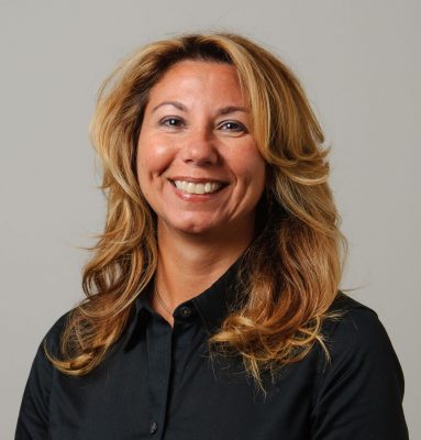 White woman with brown eyes and blond/brown hair in a black shirt.