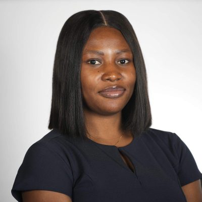 A woman with short hair wearing a black shirt smiling at the camera.